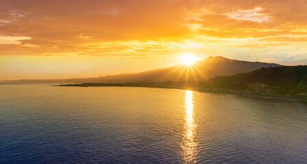 picturesque view to a sunset sea gulf with beautiful mountains and amazing cloudy sky on background of nice travel landscape