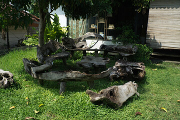Fototapeta premium Rustic Outdoor Wood Furniture in a Garden Setting With Natural Decor