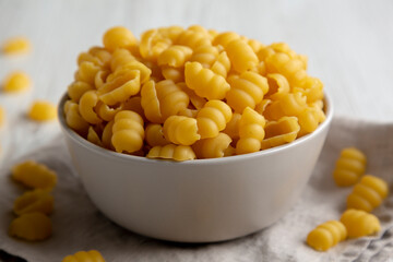 Homemade Dry Raw Gnocchi Pasta in a Bowl, low angle view. Close-up.
