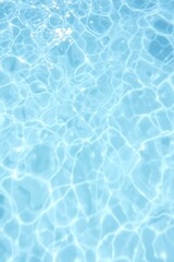 Obraz premium Rippling water surface, crystal clear blue pool, sunlight reflections, tranquil aquatic texture, high contrast ripples, summer vibes, refreshing aqua tones, abstract water patterns