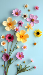 Creative abstract composition with various spring flowers on pastel blue background. Minimal fly or levitate natural concept with place for text, origami, with white tones