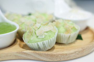 kue mangkok or kue apem or steamed rice cake that look like cup cake and usually sold in a small paper cup.Young coconut pandan cake
