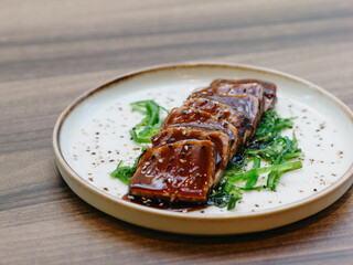 Tuna tataki with wakame and teriyaki sauce in luxury restaurant
