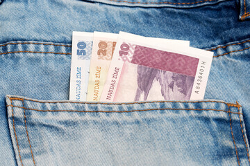 Latvian lats in the pocket of blue jeans