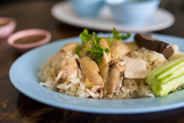 Slice boiled chicken topping on rice steamed. Featuring tender boiled chicken breast and fragrant white rice.