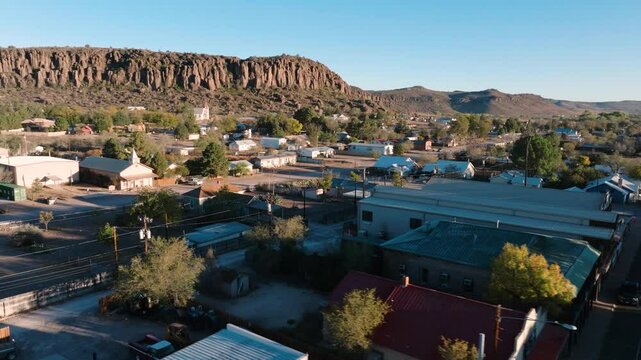 Small rural Texas town at sunrise, beautiful mountain backdrop with local church, houses and shops near Big Bend National Park in 4k