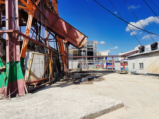 Abandoned amusement park site reveals colorful structures and a clear blue sky in a forgotten corner of the city