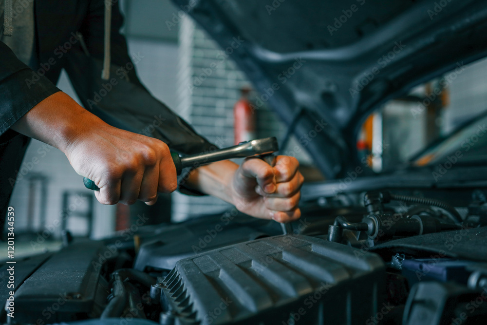 Poster Close-up of a mechanic's hands using a wrench to perform maintenance on a car engine in a workshop setting