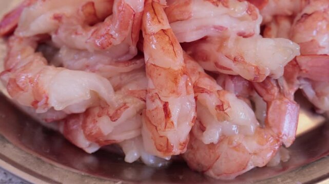 Scallops without shells, shrimp and squid on a plate, cooking seafood