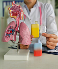Cancer from smoking e-cigarette. Oncology from smoking e-cigarette model of lungs and respiratory...