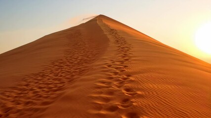 Footprints of man going up to the top of the famous dune quarantacinque.Namib Desert, Namibia. Namib- Naukluft National Park, Namibia, Africa. REAL PHOTO animated by AI - Powered by Adobe