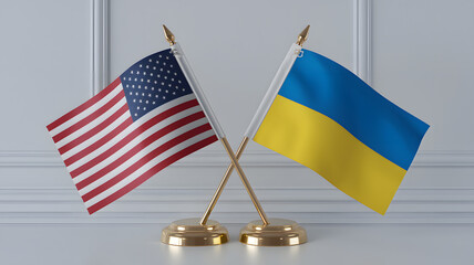 A photo of two table flags crossed at an angle on a golden stand. The flag on the left is the United States flag,