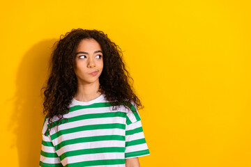 Fototapeta premium Portrait of pretty young girl look empty space wear striped t-shirt isolated on yellow color background