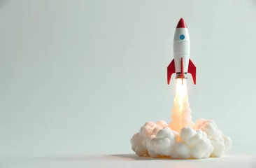 3d model of a rocket taking off on a light background with copy space. concept for the successful launch of a new startup business project © Natalia