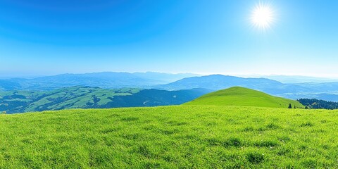 Fototapeta premium Sunny mountaintop meadow, scenic vista, rolling hills, summer day. Ideal for travel brochures