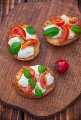 Caprese bruschetta with mini mozzarella cheese, cherry tomato and basil