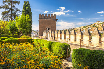 Alhambra complex in Granada town, Andalusia, Spain. Historic castle wall with vibrant flower garden © Viliam