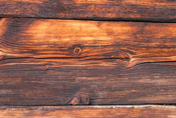 Obraz premium horizontal wooden planks of an old Swiss mountain hut darkened by the sun and winter weather of the Alps, Switzerland