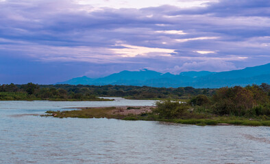 Evening shot of the banks of the Rio Magdalena or Magadalena River, Villavieja, Huila, Colombia. Clouds. Mystic atmosphere.