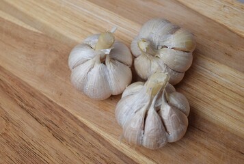 whole garlic on a wooden chopping board background. used as a spice for cooking