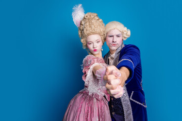 Elegant couple against a vibrant blue background, reflecting the distinctive style and grace of...