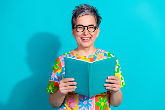 Photo of nice aged woman hold read book wear t-shirt isolated on teal color background