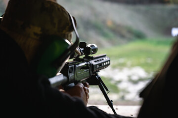 Training shooting weapons at an outdoor shooting range.