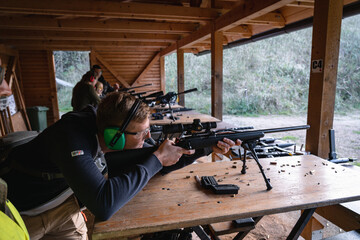 Training shooting weapons at an outdoor shooting range. - obrazy, fototapety, plakaty