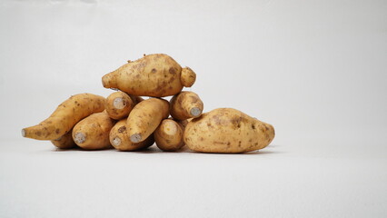 Fototapeta premium Group of fresh local raw honey sweet potatoes isolated on white background.