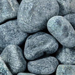 Dry rough round dark stones close up