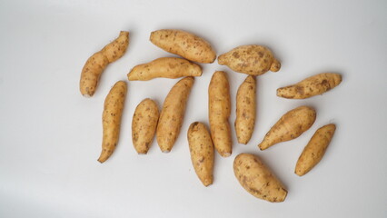 Group of fresh local raw honey sweet potatoes isolated on white background.