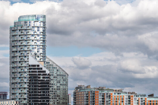 An impressive photo of architectural forms contrasted against a dramatic cloudy sky, illustrating the blend of nature and human creativity in the contemporary landscape in London UK