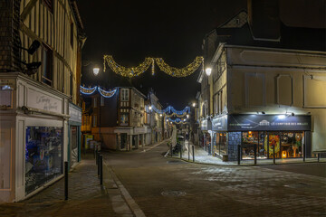 Normandy, France -12- 30- 2024 : Exterior night photo view of christmas light decorations for xmas celebrations decor evening with garlands and tinsel lights,