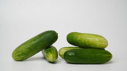 A bunch of fresh cucumbers isolated on a white background.