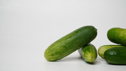A bunch of fresh cucumbers isolated on a white background.