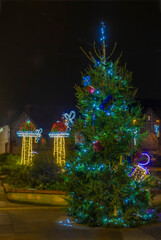 Normandy, France -12- 30- 2024 : Exterior night photo view of christmas light decorations for xmas celebrations decor evening with garlands and tinsel lights,