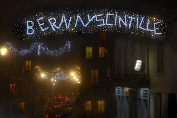 Normandy, France -12- 30- 2024 : Exterior night photo view of christmas light decorations for xmas celebrations decor evening with garlands and tinsel lights,