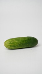 A fresh cucumber isolated on a white background.
