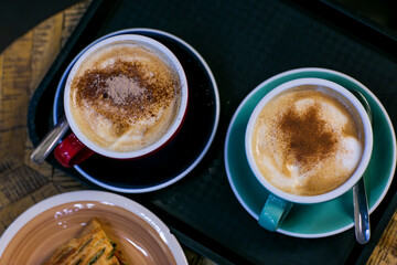cup of coffee with spinach pie close up photo with human hand. High quality photo