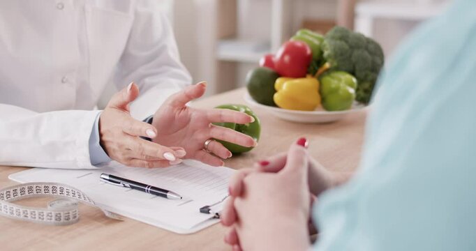 Dietician, nutrition specialist consulting, developing healthy diet, dietary programme. Dietary consultant giving overweight patient advice, medical counseling, nutritional information and meal plan