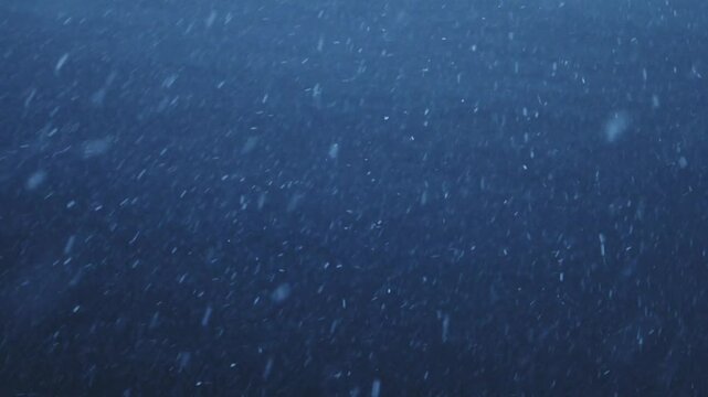 Snow Snowing Close Up Detail with Ocean Sea Water in Dark Blue Scene in Antarctica on Antarctic Peninsula, Slow Motion Snowflakes Falling in Snow Blizzard in Winter