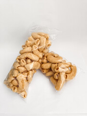 two packs of light snacks of dry macaroni on a white background.