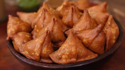 Indian Food – Samosa is a famous Indian cuisine snack, a crispy pastry filled with spiced potatoes and peas. A must-try street snack found at restaurants and food stalls in India.