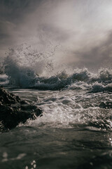 A large wave crashing into the shore
