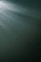 A dark blue background with a light shining on it