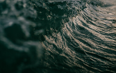 The wave in the ocean, with the water appearing to be dark
