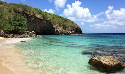 Fototapeta premium Clear turquoise water gently laps against rocky shoreline at beach