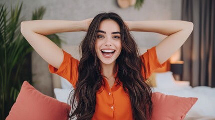 Fototapeta premium Joyful woman holding pillows in a playful bedroom, exuding excitement and happiness with her wide smile.