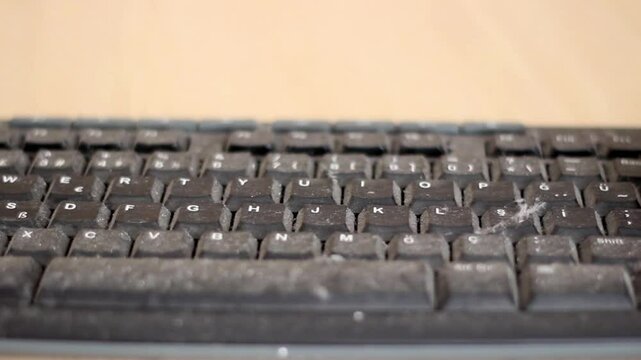 Fingers cleaning keyboard