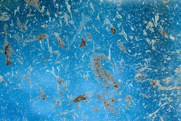 texture and background of dirty and dusty glass surface. Frosted glass texture with blue background. defocused